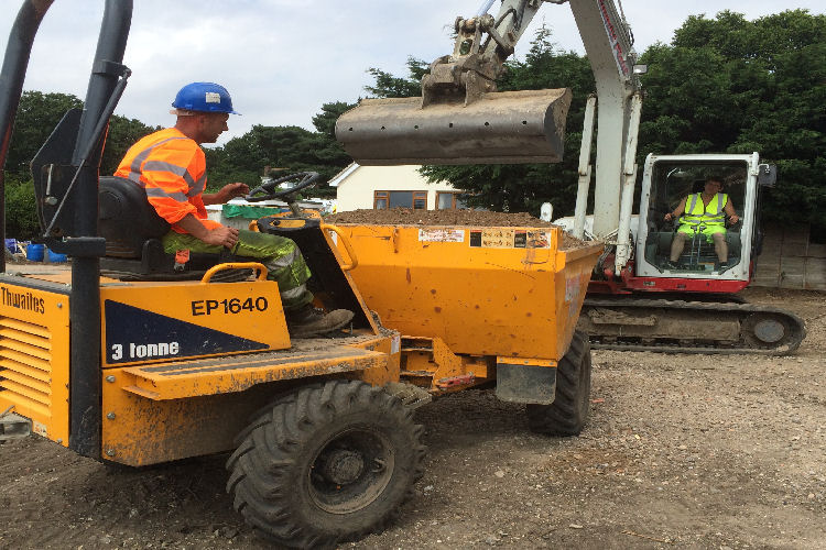 a digger loading a dumper